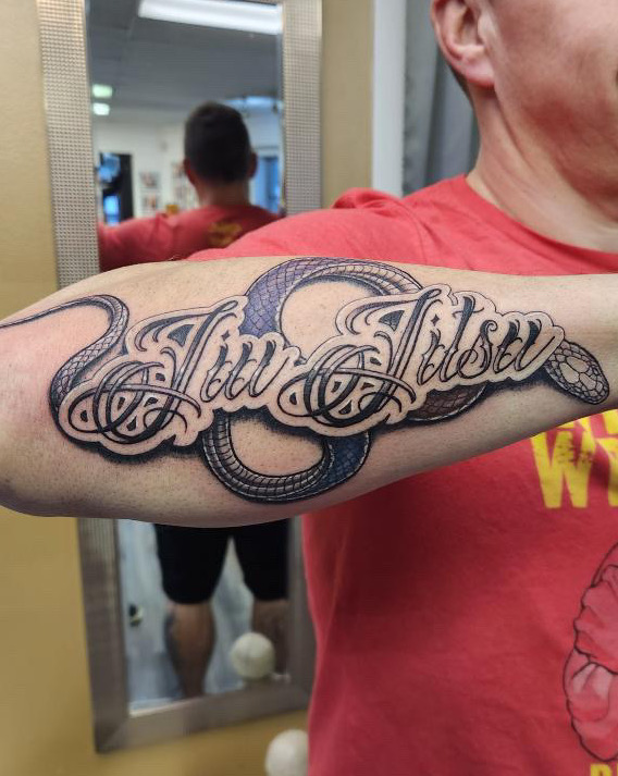 Black and grey snake with Jiu Jitsu Tattoo by Britney Farmer of Sacred Mandala Studio.